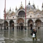 A man wearing thigh boots crosses St. Mark's square by St. Mark's Basilica after an exceptional overnight "Alta Acqua" high tide water level, early on November 13, 2019 in Venice. - Powerful rainstorms hit Italy on November 12, with the worst affected areas in the south and Venice, where there was widespread flooding. Within a cyclone that threatens the country, exceptional high water were rising in Venice, with the sirocco winds blowing northwards from the Adriatic sea against the lagoonís outlets and preventing the water from flowing back into the sea. At 22:40pm the tide reached 183 cm, the second measure in history after the 198 cm of the 1966 flood. (Photo by Marco Bertorello / AFP)