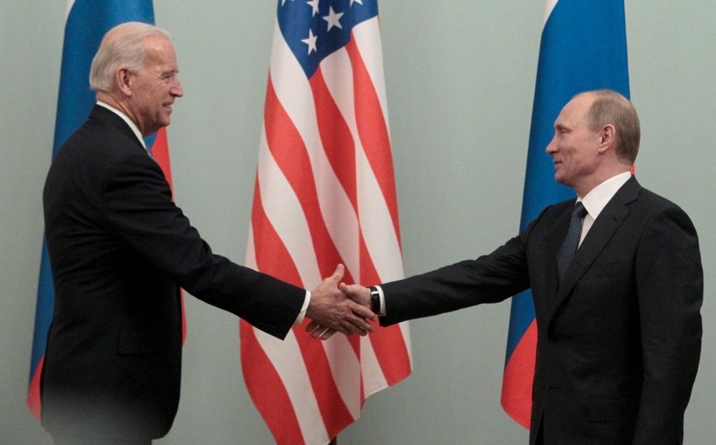 FILE PHOTO: Russian Prime Minister Vladimir Putin shakes hands with U.S. Vice President Joe Biden during their meeting in Moscow March 10, 2011. REUTERS/Alexander Natruskin/File Photo